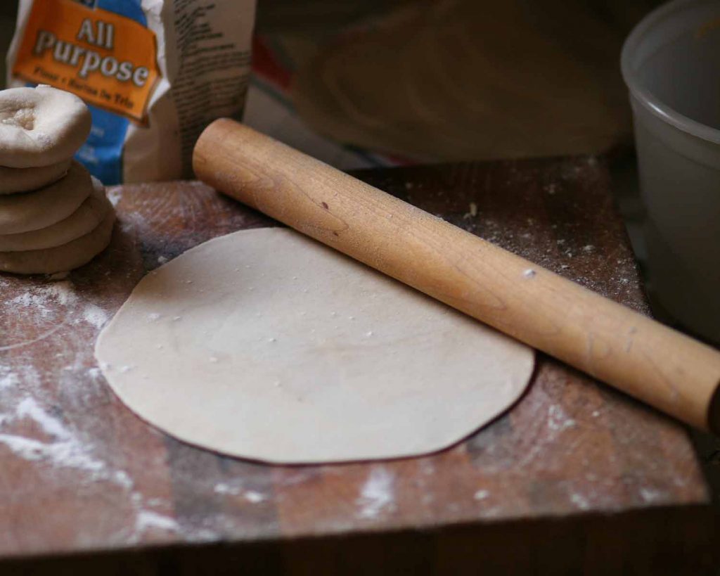 Floured board with rolled out flour tortilla