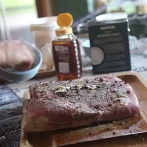 Massaging the cure and spice mix into the pork belly
