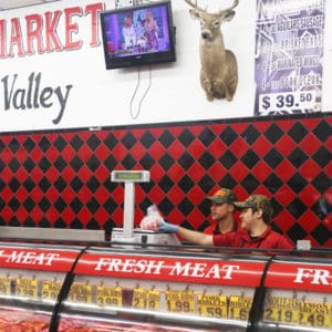 Izael and Angel, the next generation of butchers, consulting on a purchase