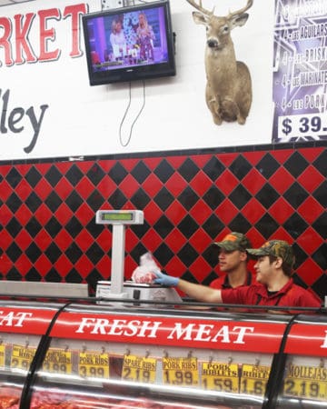 Izael and Angel, the next generation of butchers, consulting on a purchase