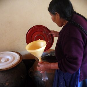 Woman filling bottle of chicha
