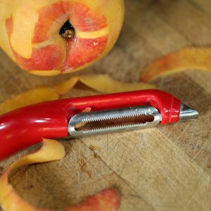 Peeling ripe peaches with soft skin peeler