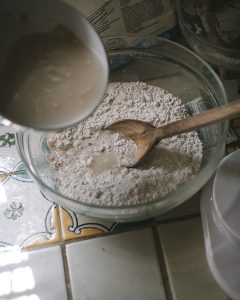 Stirring yeast into Rosemary Sea Salt Crackers with Truffle Oil