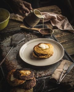 Pouring Oatmeal Pancakes with Pears and Vanilla Cream over Oatmeal Pancakes with Pears