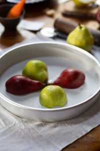 Cinnamon poached pears arranged in pan