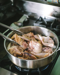 Chicken browing in a covered pan