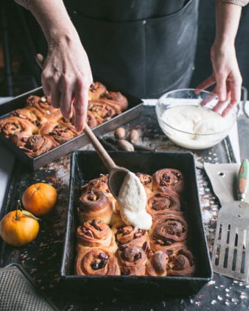 Spreading glaze on cinnamon rolls