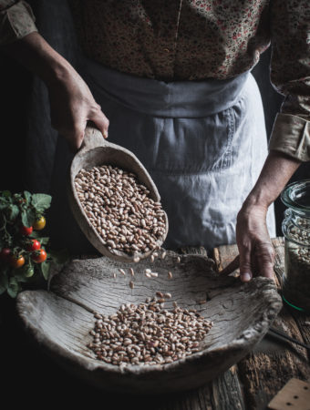 woman pouring dried beans