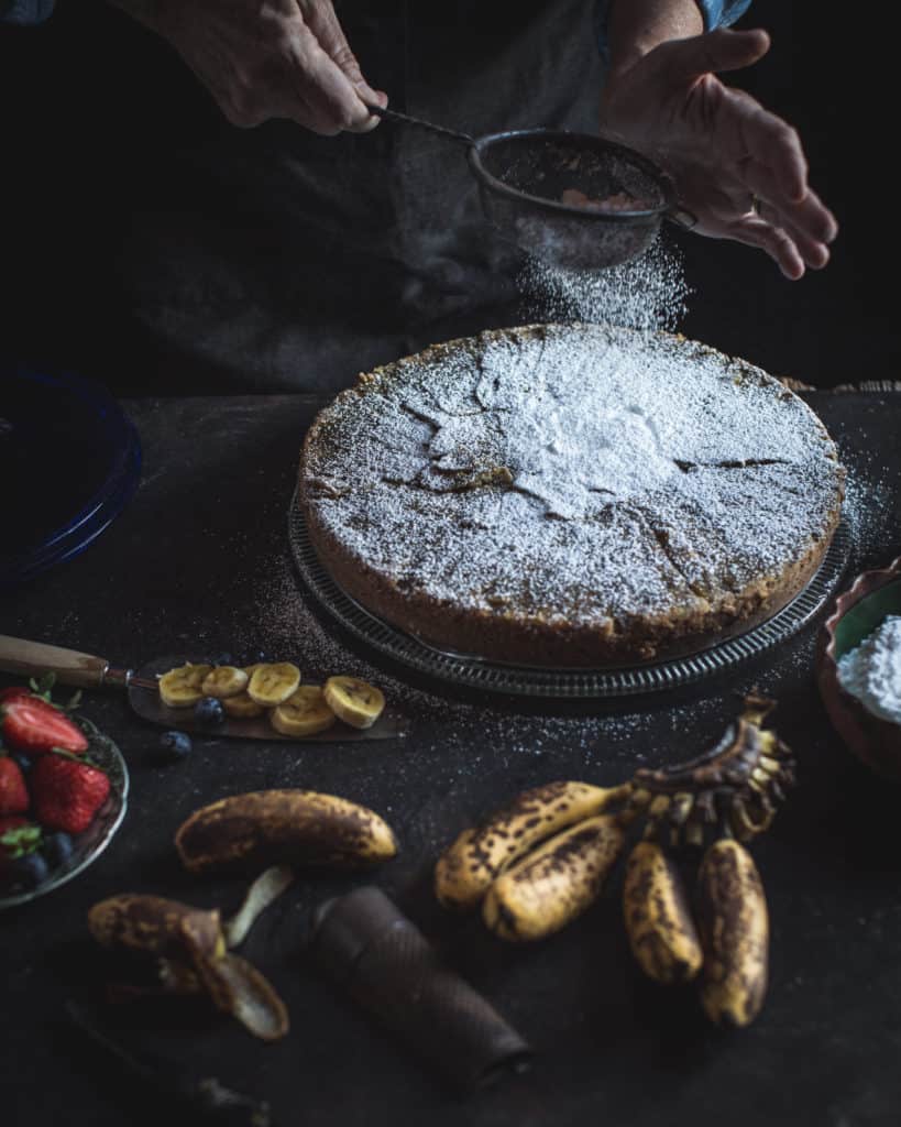 dusting a cake with sugar