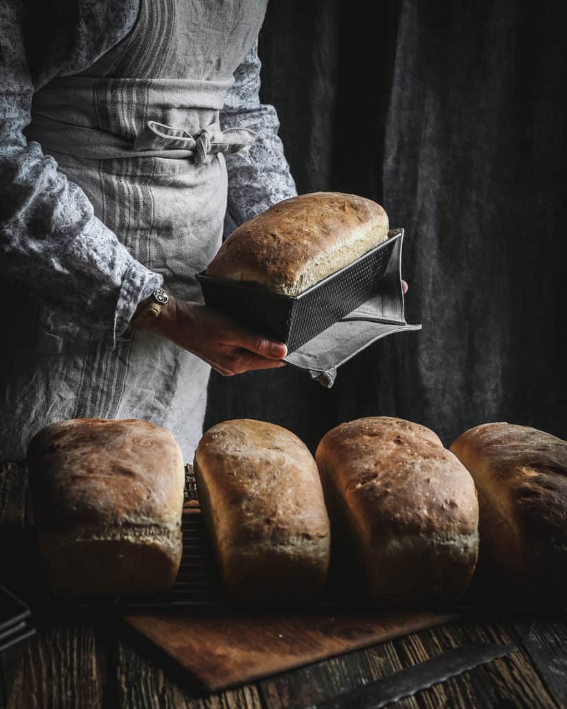 woman hold loaf of bread