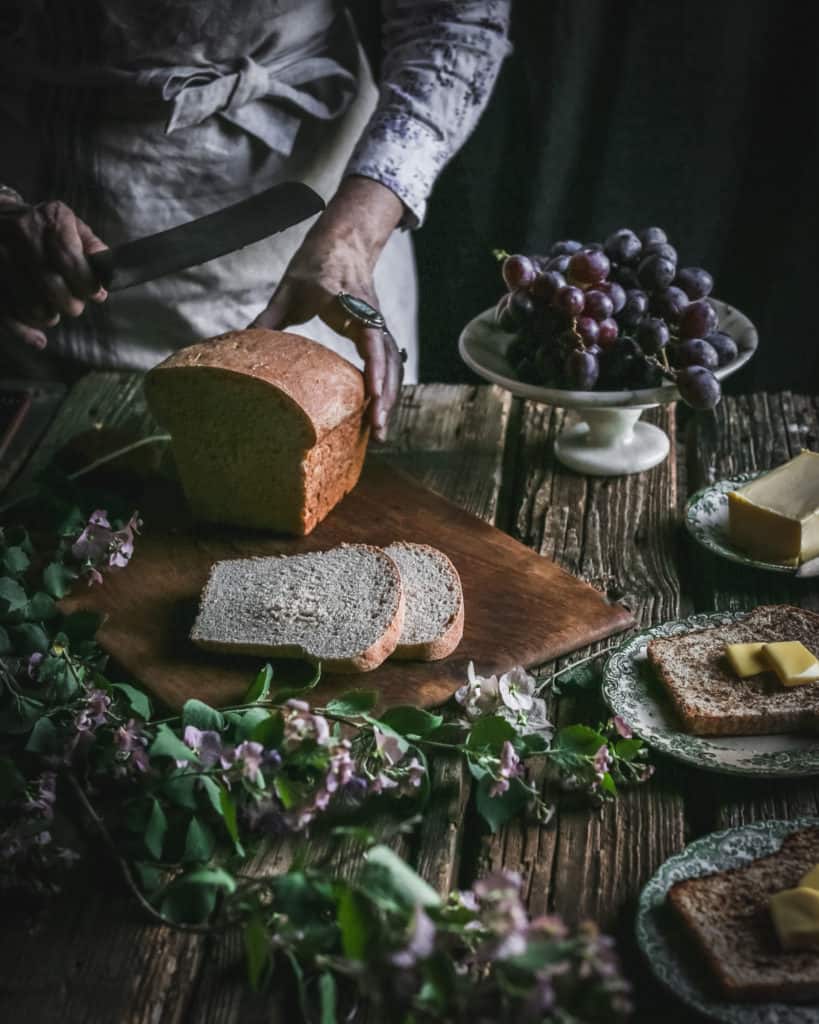 hands slicing bread