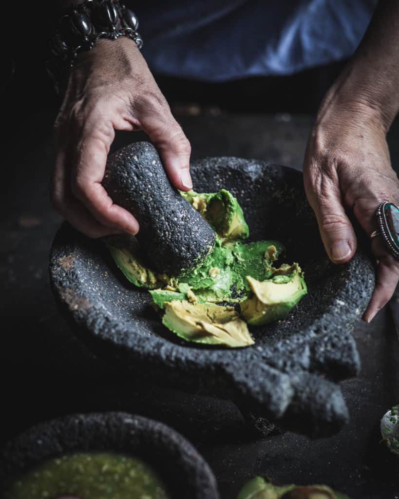 hand mashing avocados