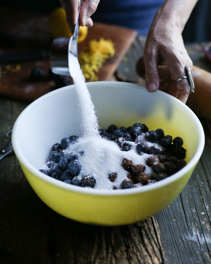 pouring sugar onto berries