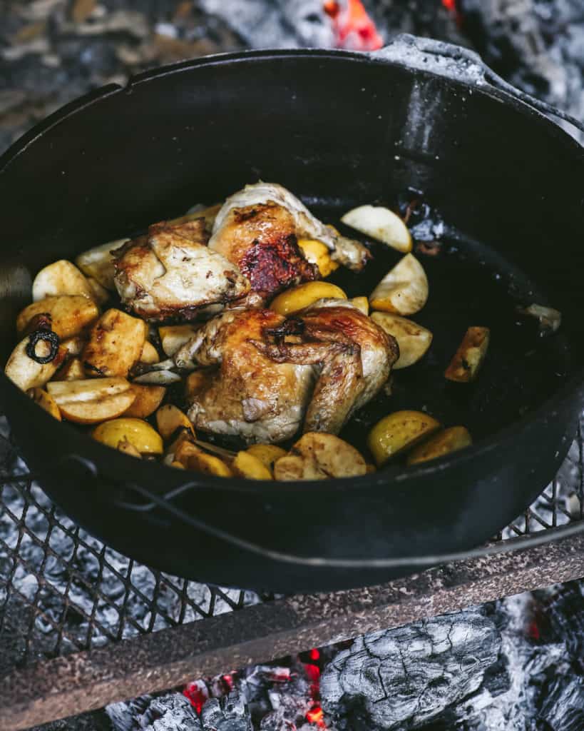 pan of chicken and apples over fire