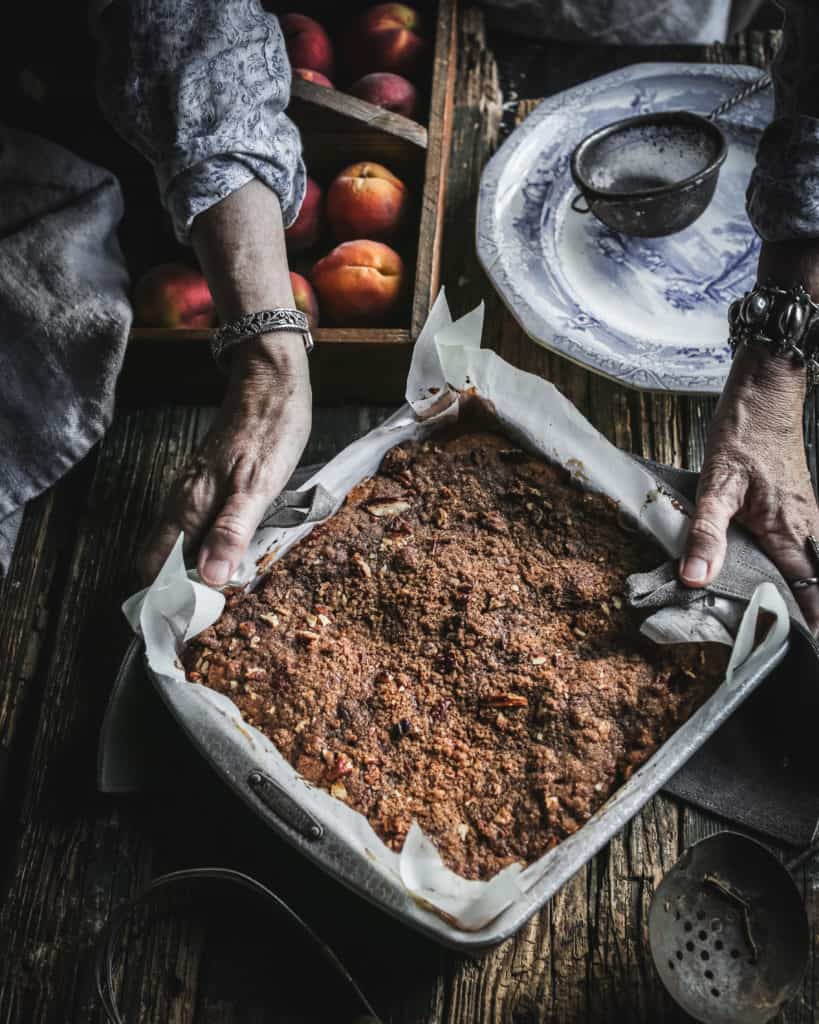 hands holding baked coffee cake