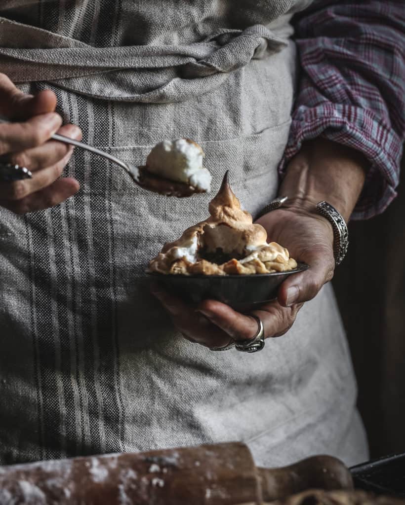 woman with spoon and small pie