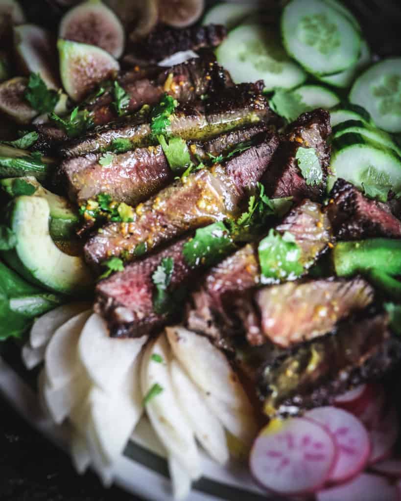 close up of steak salad with dressing