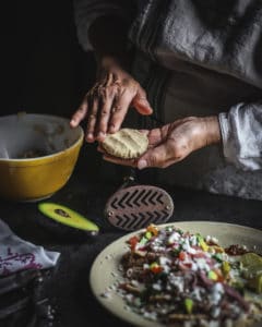 woman's hands patting dough