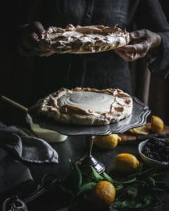 topping Brown Sugar Pavlova on Pedestal with another pavlova