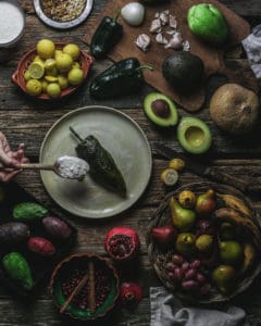 plate with chile en nogada surrounded by fruit