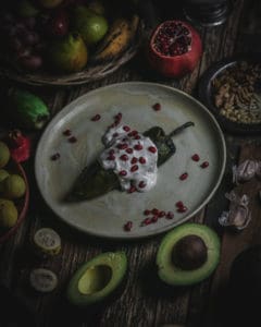 plate with chile en nogada covered in sauce