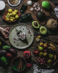plate with chile en nogada surrounded by fruit