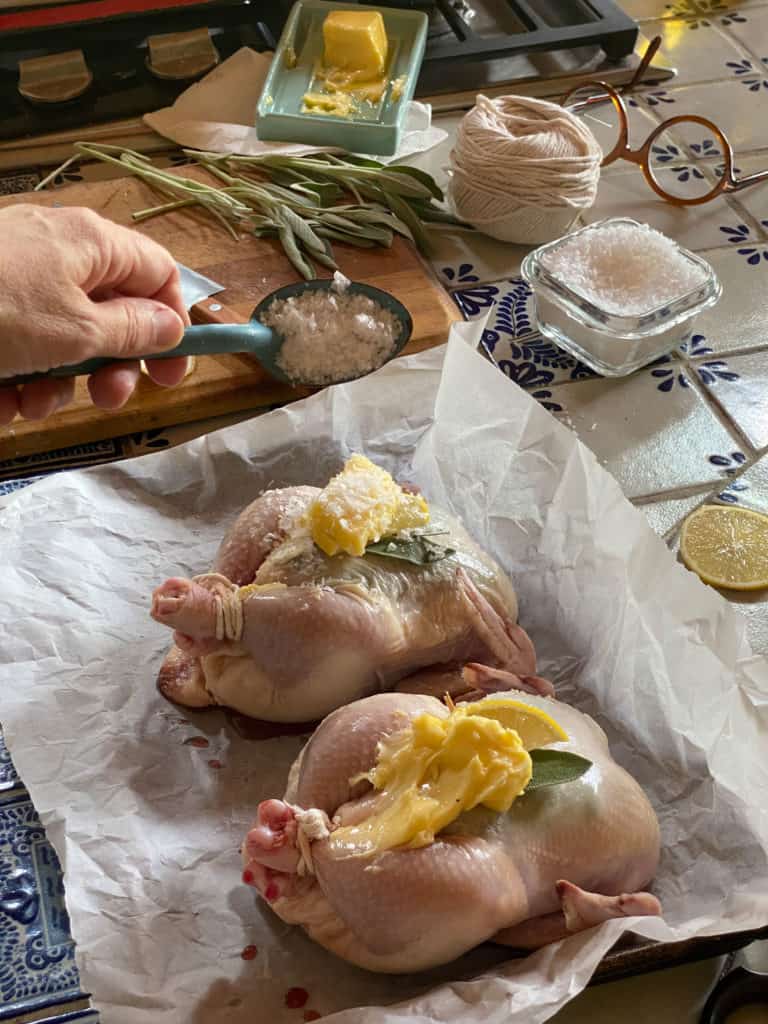uncooked Lemon Sage Cornish Game Hens topped with butter