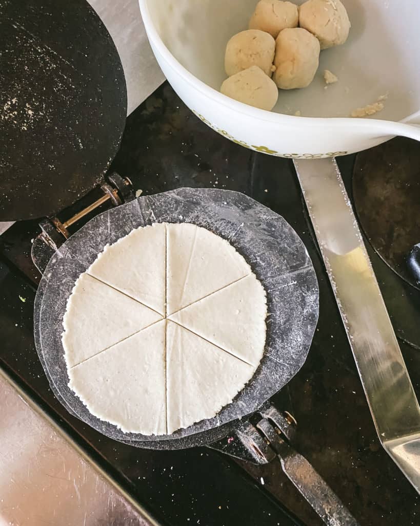 uncooked tortilla in press