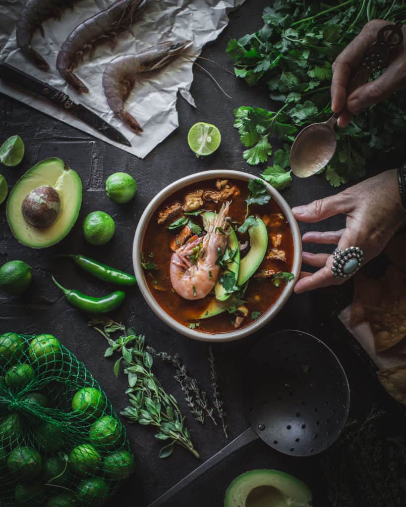 hand serving caldo de mariscos