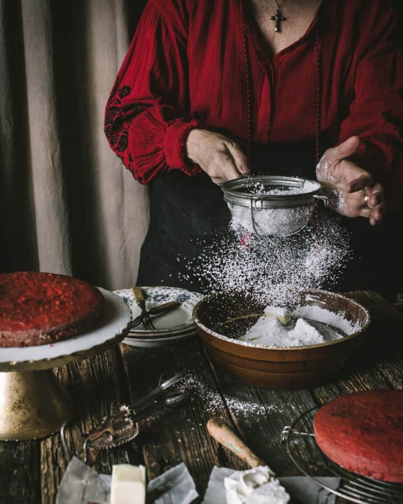 woman sifting powdered sugar