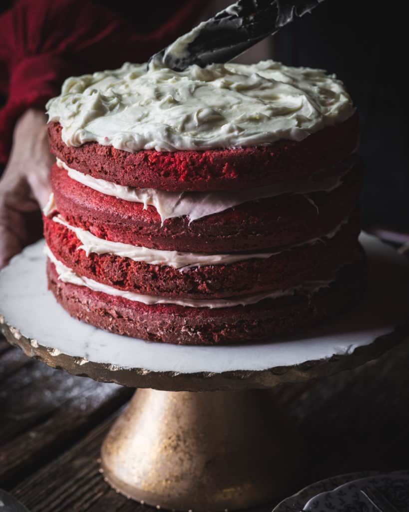 woman frosting cake