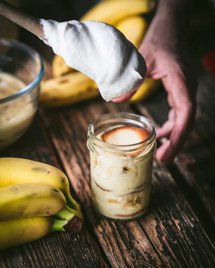 topping classic banana pudding with cream