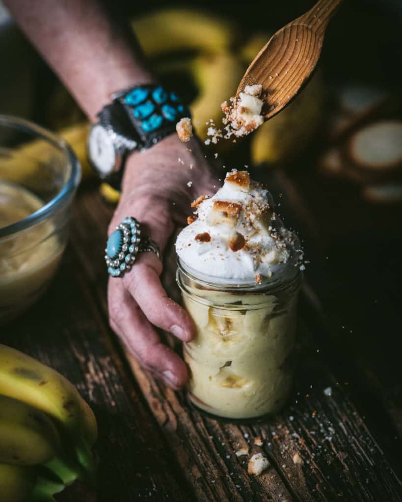 garnishing pudding with crumbled cookies