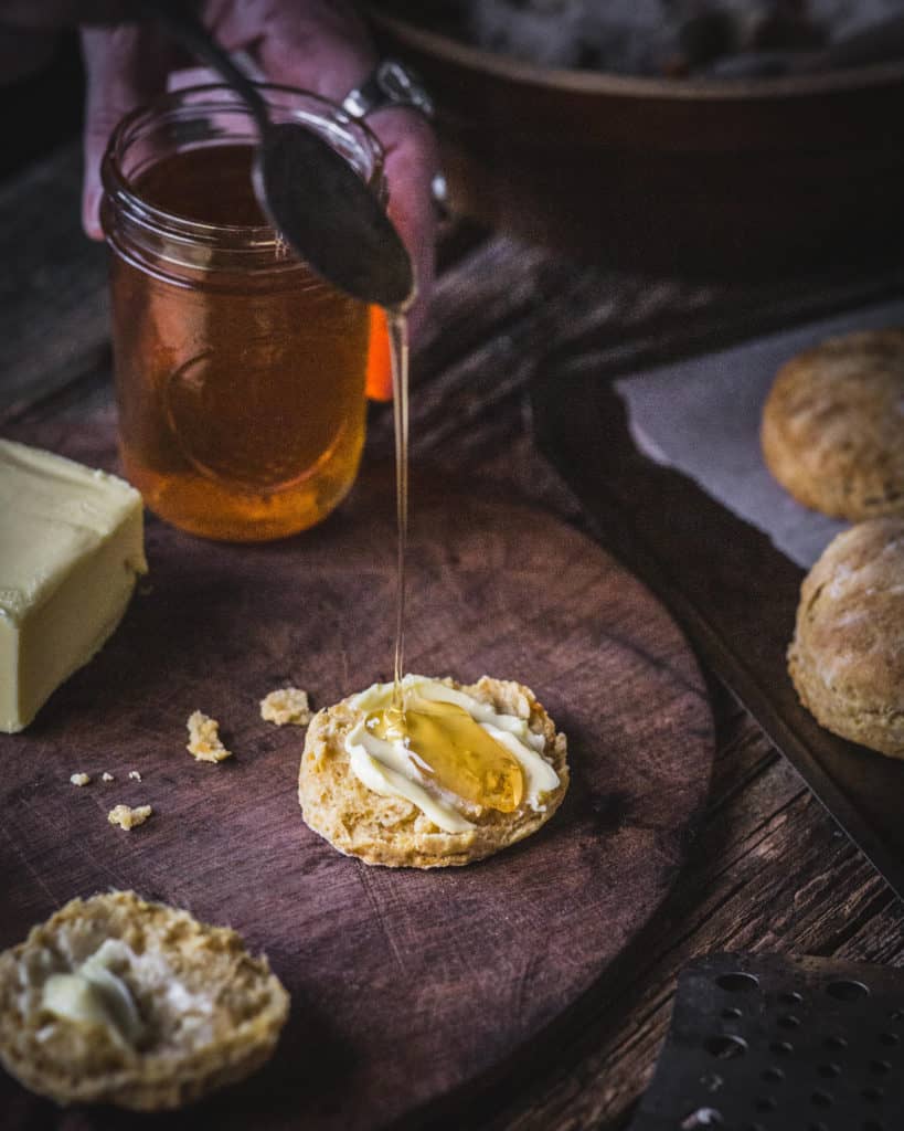 honey pouring on biscuit