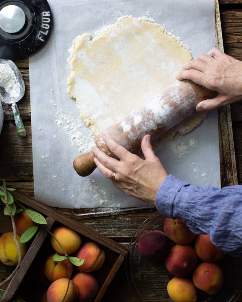 hands rolling out pie crust