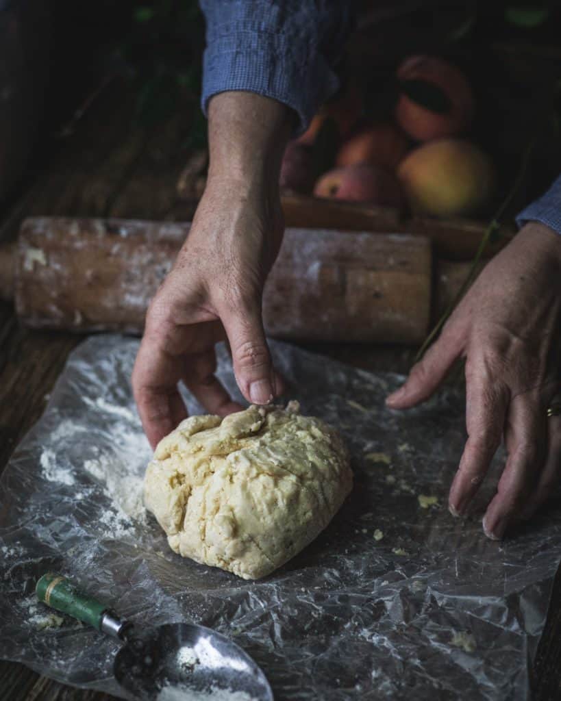 hands with ball of pie crust