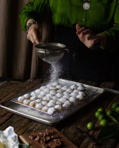 hands sifting sugar onto Lime Cooler Cookies