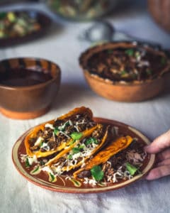 plate of lamb birria tacos