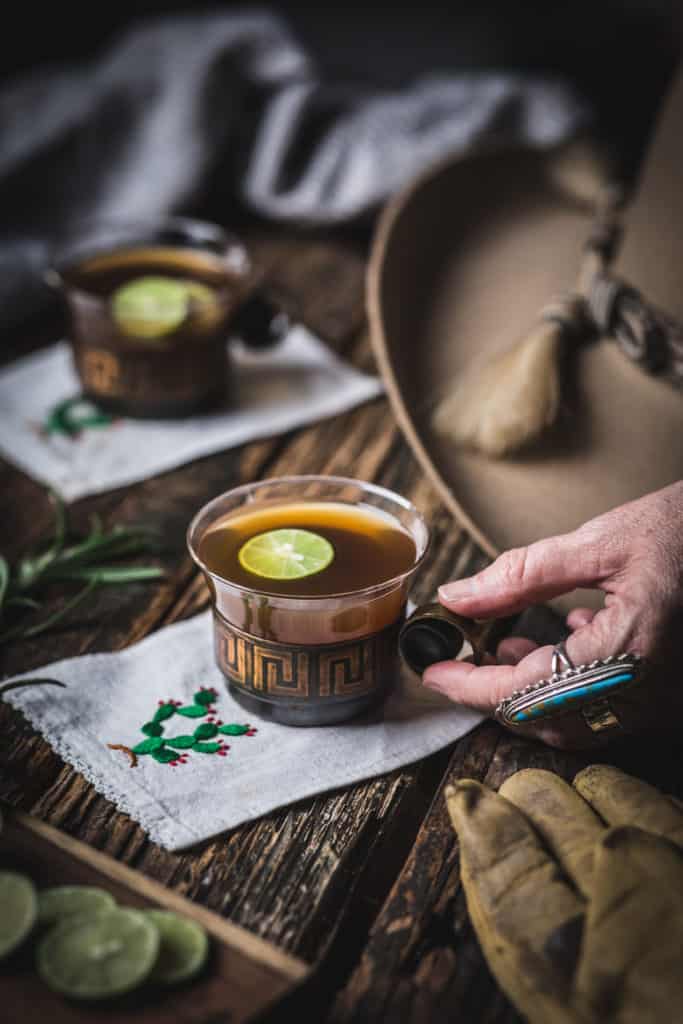 woman's hands with cup of hot bourbon tea