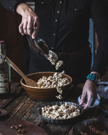 woman scooping maple bacon bourbon caramel corn