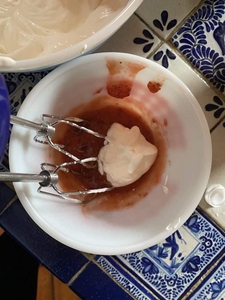 dollop of whipped cream in bowl of jam