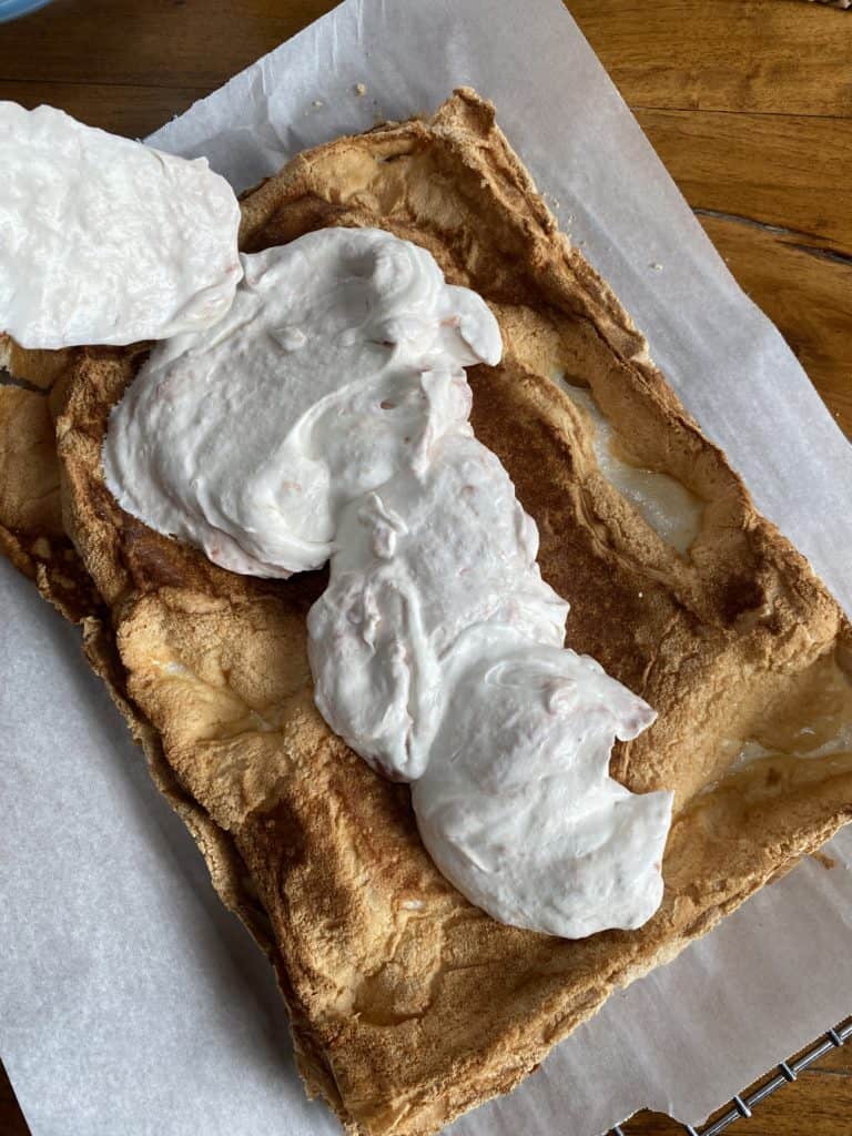 Strawberry cream filling on top of meringue