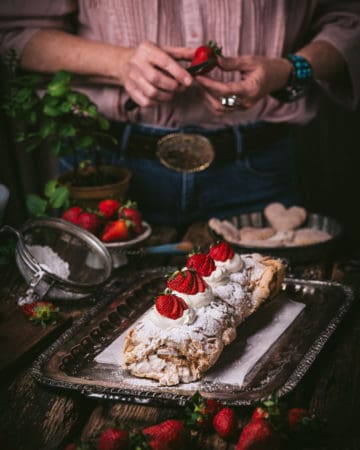 woman cutting strawberries for dessert