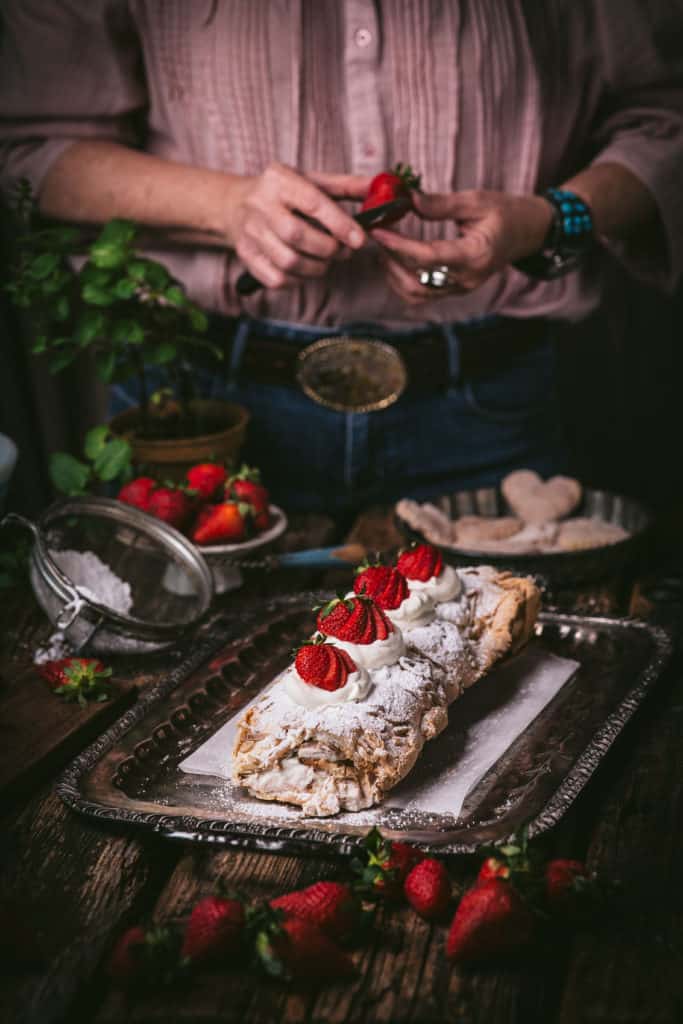 woman cutting strawberries for dessert