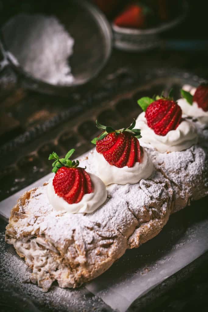 close up view of strawberry meringue roll