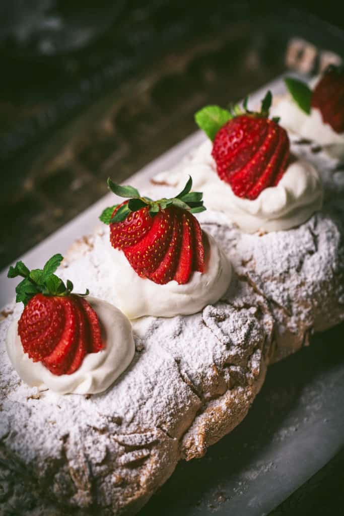 close up view of strawberry meringue roll