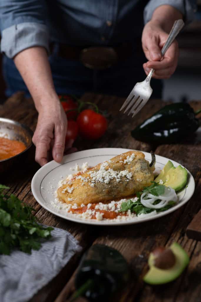 woman with chile relleno on plate