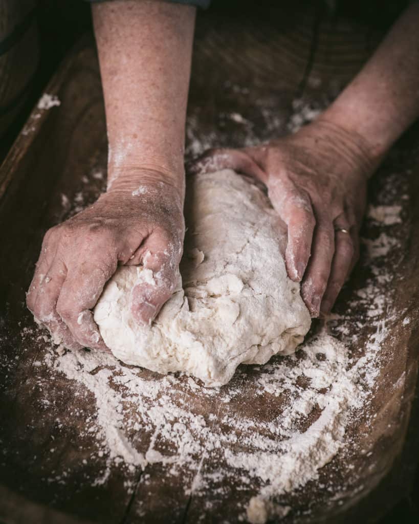 woman's hands kneading bread