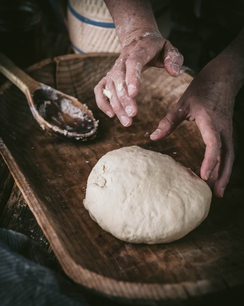 woman's hands kneading bread