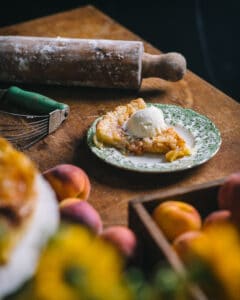 plate with serving of peach tart and ice cream